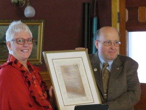 Mayor Paul Monette receiving a plaque honoring Newport as an Age Friendly City.