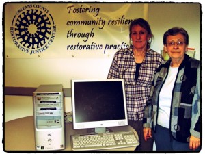 Accepting the computer at left is Deb RoseWolf of OCRJC from Madeleine Roy, Marketing Director at Green Mountain United Way.